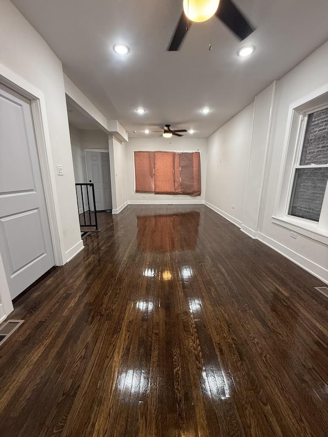 unfurnished living room featuring dark wood-type flooring