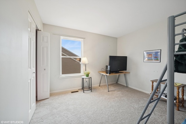 office area featuring carpet flooring, visible vents, and baseboards