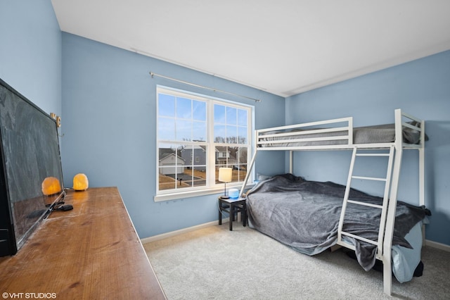 bedroom featuring carpet floors and baseboards