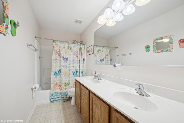 bathroom featuring visible vents, a sink, toilet, and double vanity