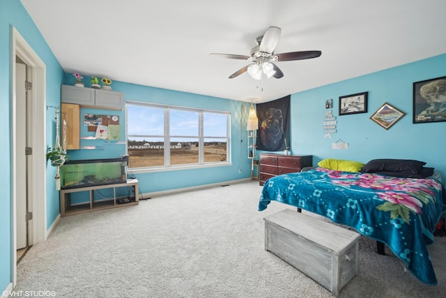 carpeted bedroom featuring a ceiling fan and baseboards