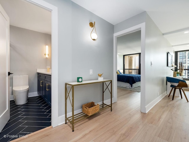 bathroom with hardwood / wood-style flooring, vanity, and toilet