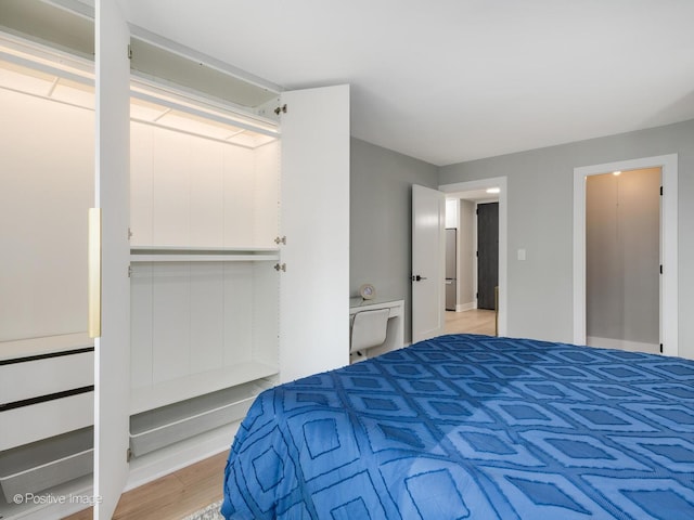 bedroom with light wood-type flooring and a closet