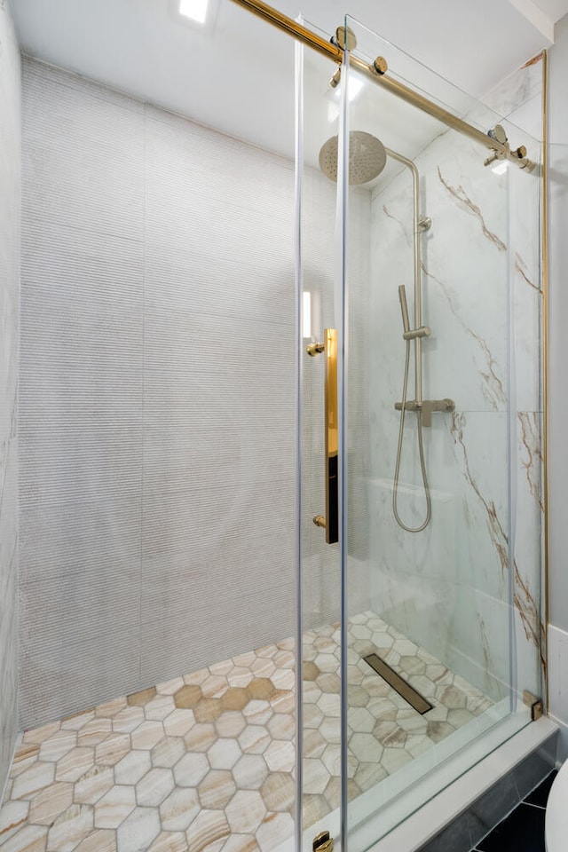 bathroom featuring tile patterned flooring and a shower with shower door