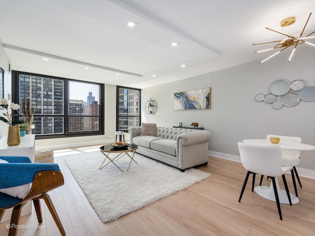 living room with light hardwood / wood-style flooring and a chandelier