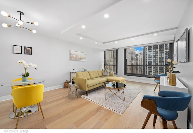 living room with light hardwood / wood-style floors and a chandelier