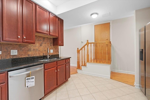 6750 N Greenview Ave Unit G, Chicago, IL 60626 - kitchen with stainless steel appliances, a sink, tasteful backsplash, dark stone counters, and baseboards