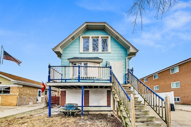 rear view of house with a wooden deck