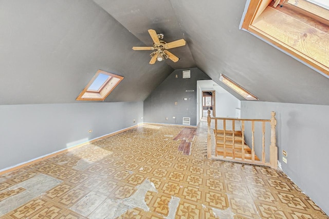 bonus room featuring ceiling fan and lofted ceiling with skylight