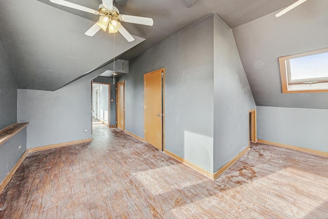 bonus room with ceiling fan, light hardwood / wood-style floors, and vaulted ceiling