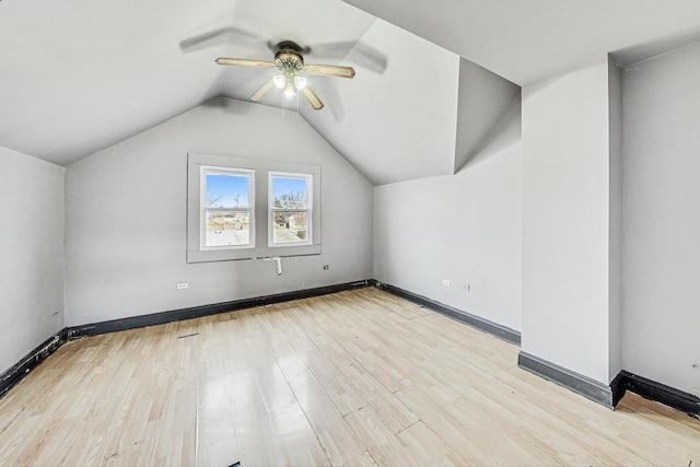 additional living space with ceiling fan, vaulted ceiling, and light hardwood / wood-style flooring