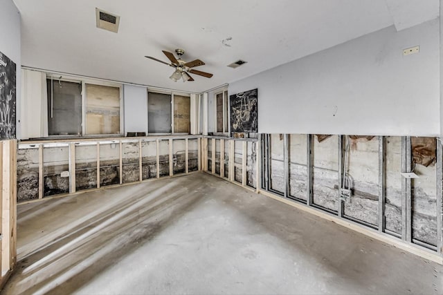 empty room with concrete flooring and ceiling fan