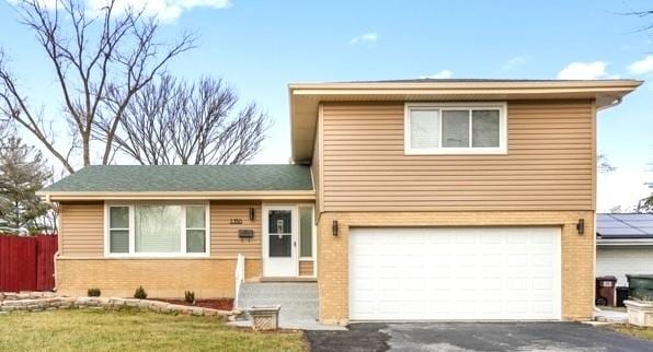 view of front of property featuring a front yard and a garage