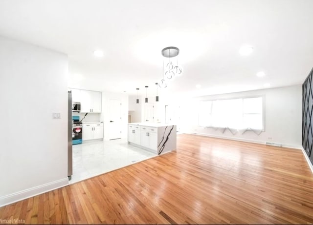 unfurnished living room featuring light hardwood / wood-style flooring