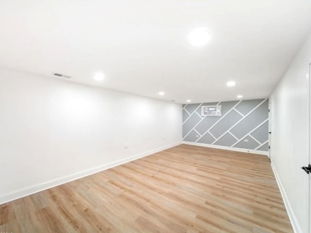 basement with light hardwood / wood-style floors