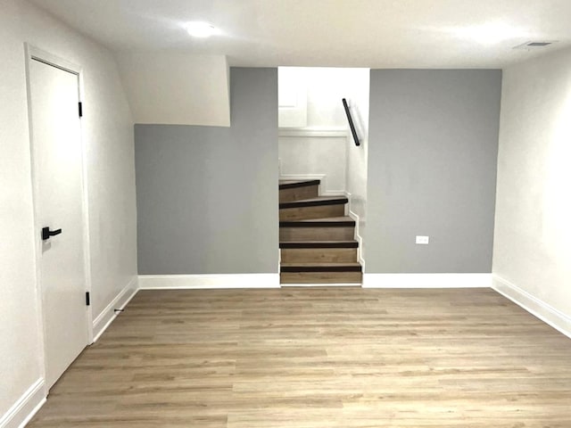 basement with light hardwood / wood-style floors