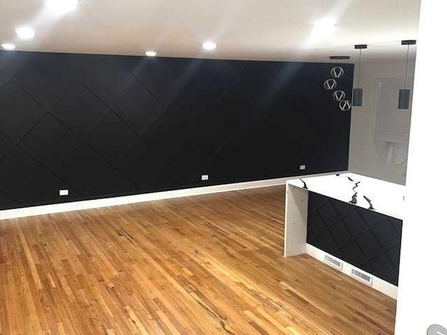 unfurnished room with hardwood / wood-style flooring