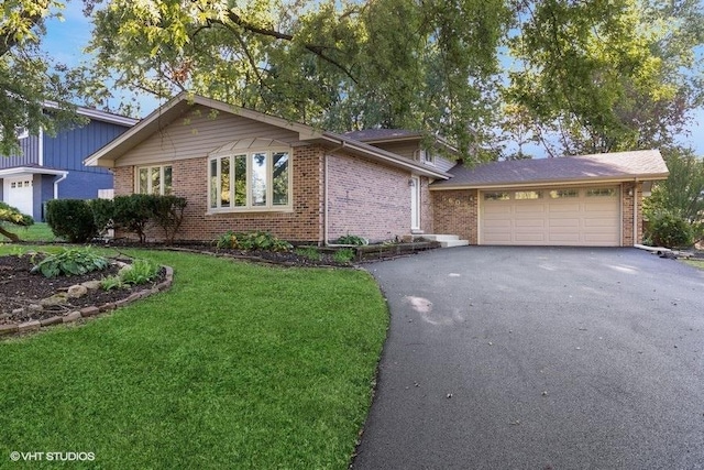 view of front of property featuring a garage and a front yard