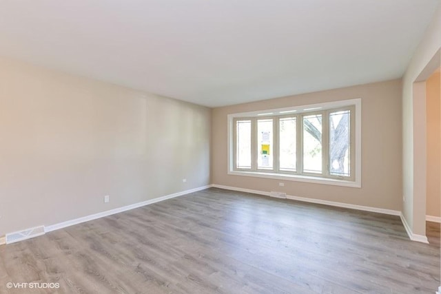 spare room with light hardwood / wood-style flooring