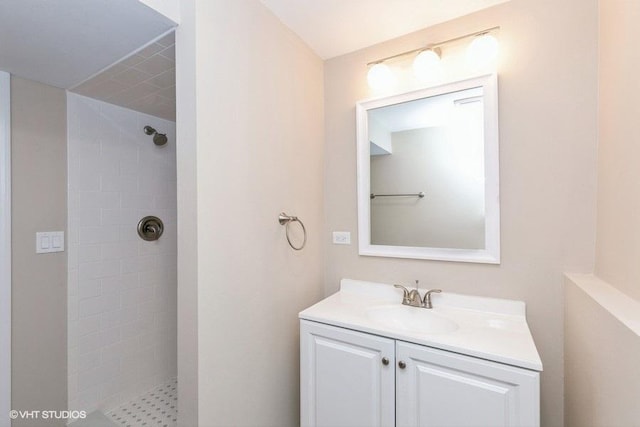 bathroom with vanity and tiled shower