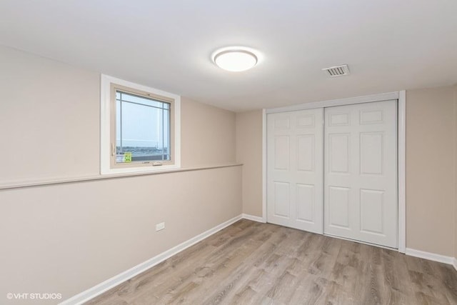 unfurnished bedroom with a closet and light wood-type flooring