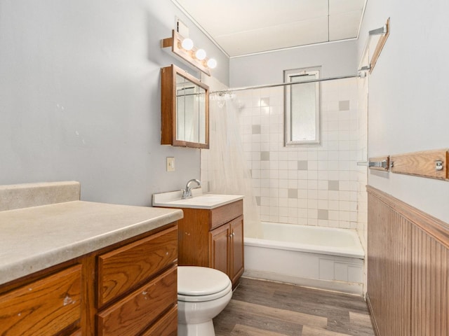 full bathroom with toilet, shower / bath combination with curtain, hardwood / wood-style floors, and vanity