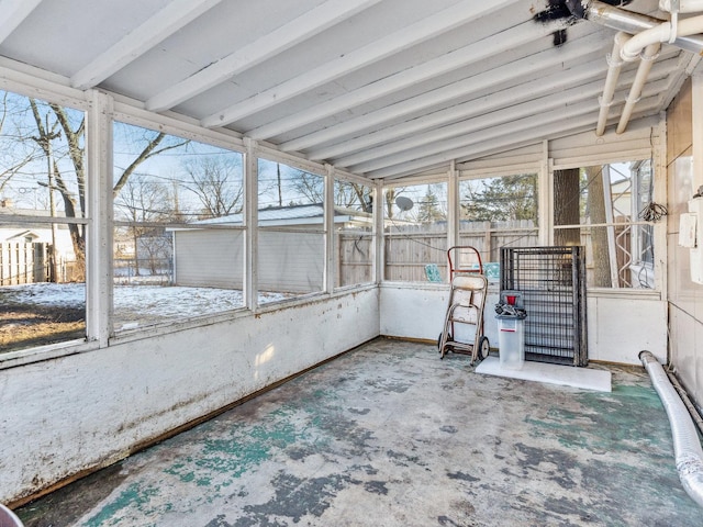 unfurnished sunroom featuring vaulted ceiling