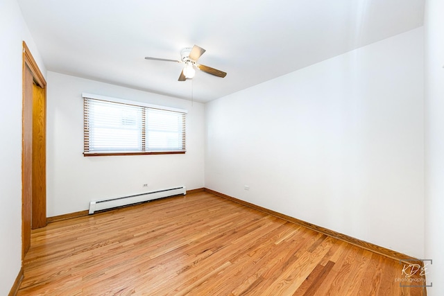 spare room with a baseboard heating unit, light wood-type flooring, and ceiling fan