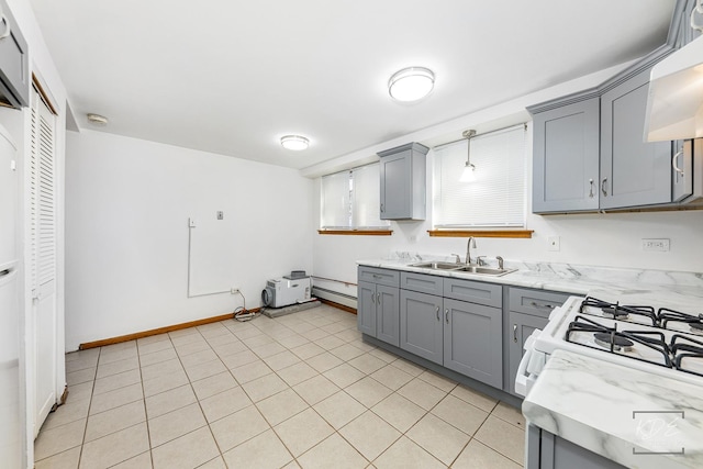 kitchen with range hood, pendant lighting, light tile patterned floors, gray cabinets, and sink