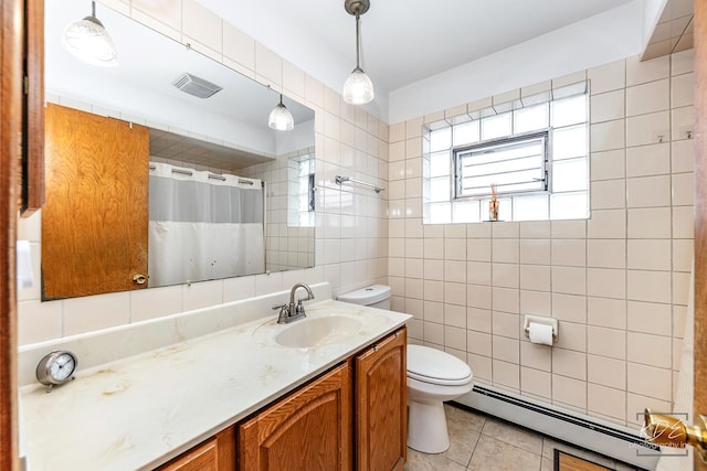 bathroom with vanity, tile walls, toilet, tile patterned floors, and a baseboard radiator