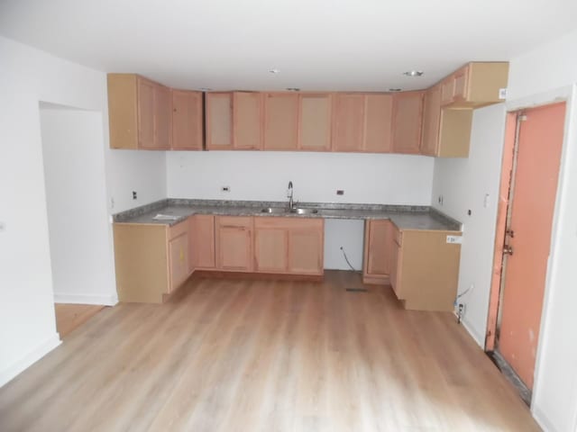 kitchen with light brown cabinetry, sink, and light hardwood / wood-style floors