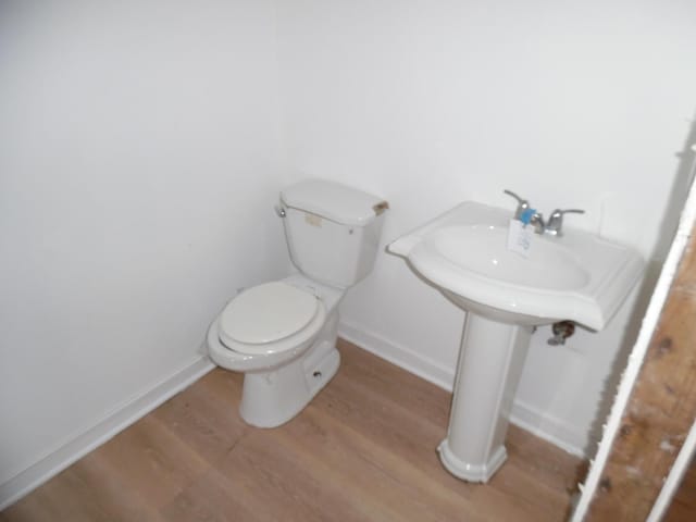 bathroom with toilet and hardwood / wood-style flooring