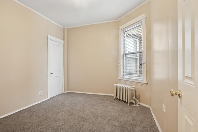 unfurnished room featuring radiator heating unit, carpet floors, and ornamental molding