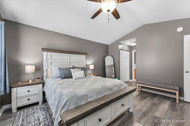 bedroom with lofted ceiling, ceiling fan, a closet, and dark hardwood / wood-style floors