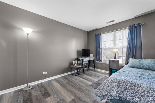 bedroom with hardwood / wood-style floors