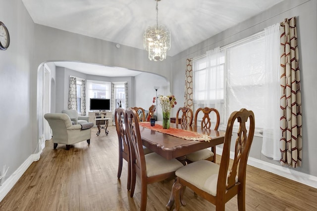 dining room featuring hardwood / wood-style floors and an inviting chandelier