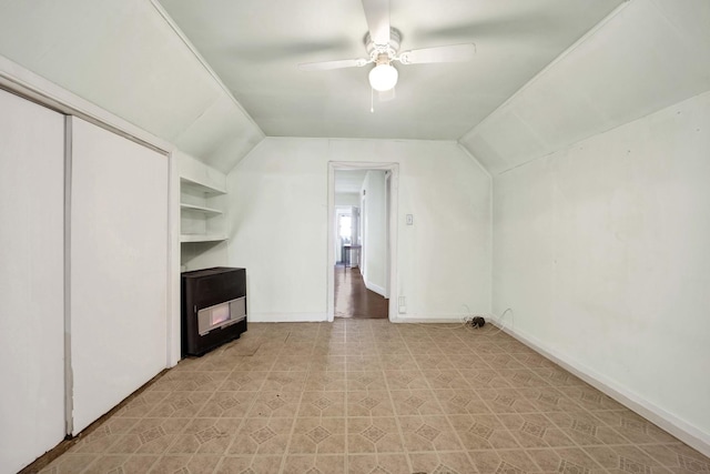 bonus room featuring ceiling fan, built in features, and lofted ceiling