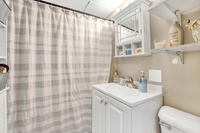 bathroom with vanity and toilet