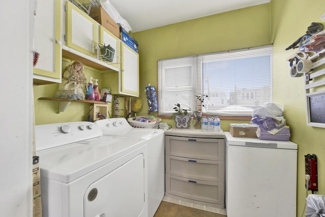 laundry area featuring cabinets and separate washer and dryer