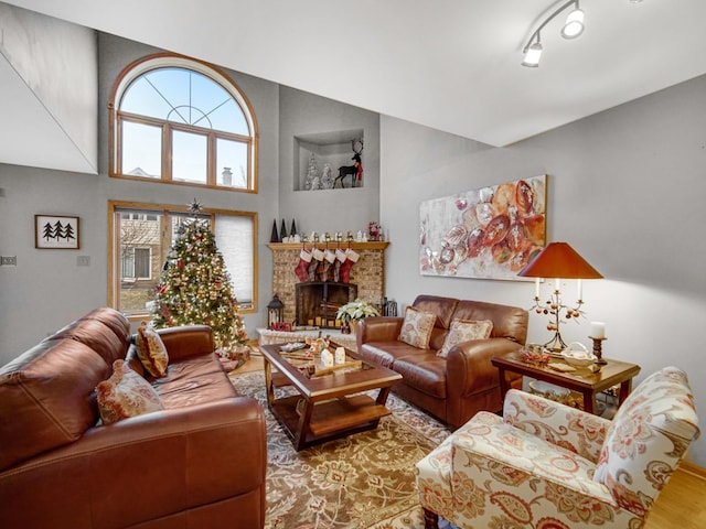 living room with a brick fireplace and hardwood / wood-style floors