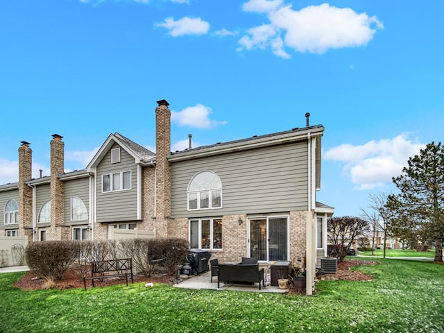 back of property featuring central AC, a patio area, and a yard