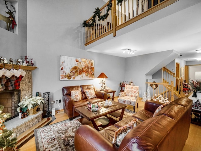 living room featuring a brick fireplace and light hardwood / wood-style flooring