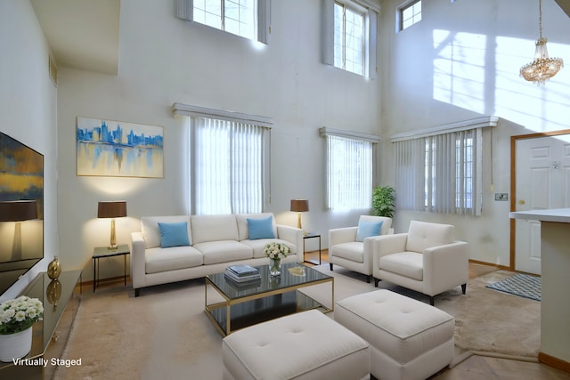 living room featuring an inviting chandelier and a towering ceiling