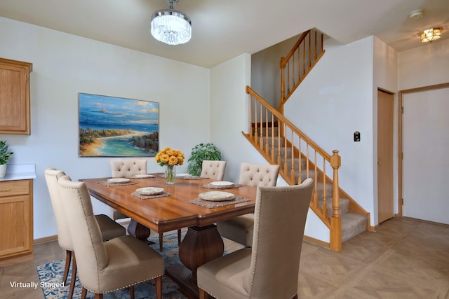 dining room with an inviting chandelier and light parquet flooring