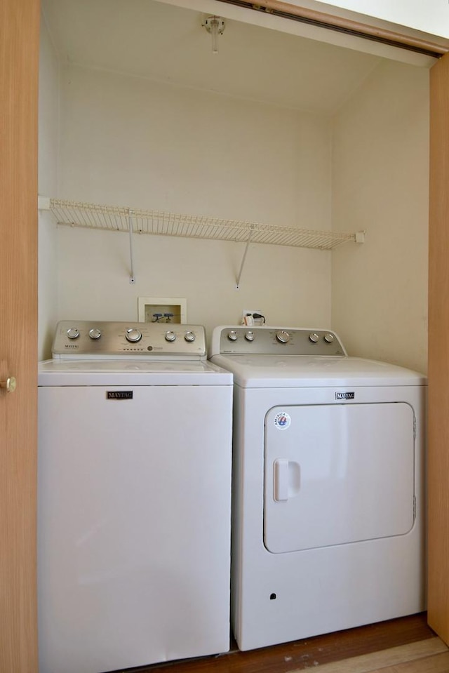 laundry area with washing machine and clothes dryer