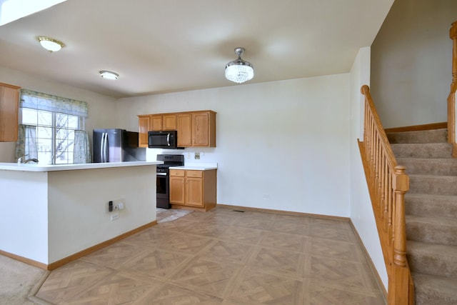 kitchen with range, light parquet flooring, and stainless steel fridge