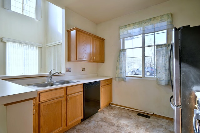 kitchen with sink, stainless steel fridge, dishwasher, and plenty of natural light