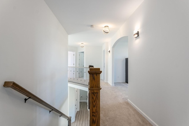 corridor featuring light colored carpet