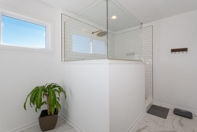 bathroom featuring a tile shower