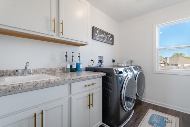 washroom with separate washer and dryer, dark wood-type flooring, cabinets, and sink